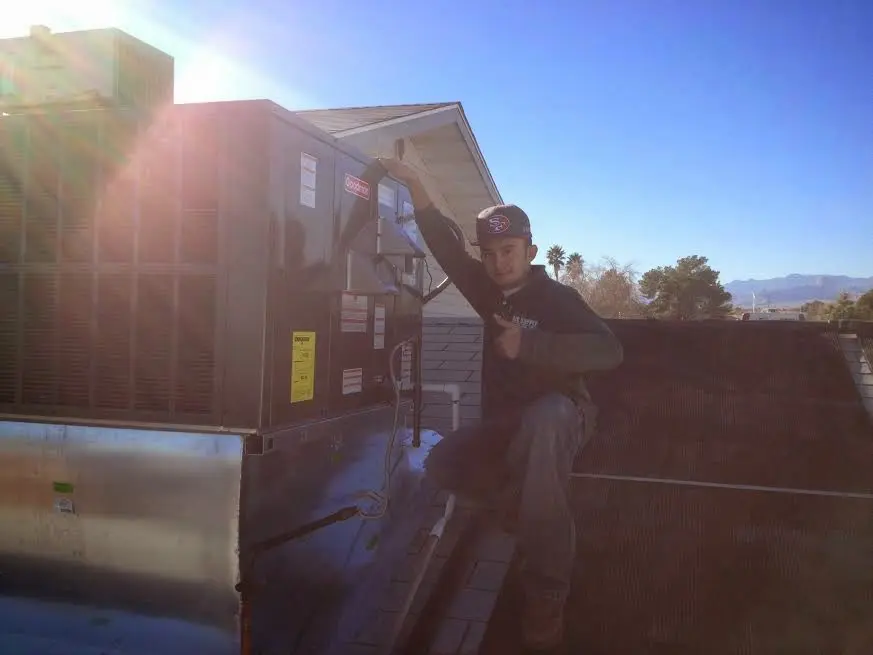 HVAC technician performing HVAC Inspection on a rooftop unit in Eagle Mountain